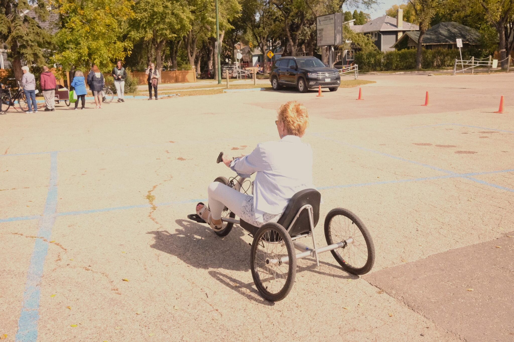 An older Woman rides a recumbent bike 