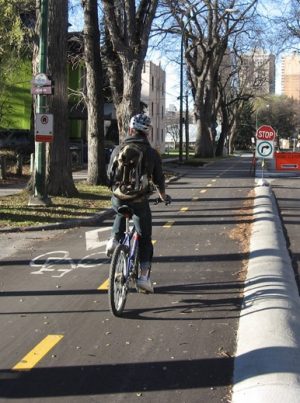 Riding the Assiniboine Ave cycle track (Photo by Anders Swanson)