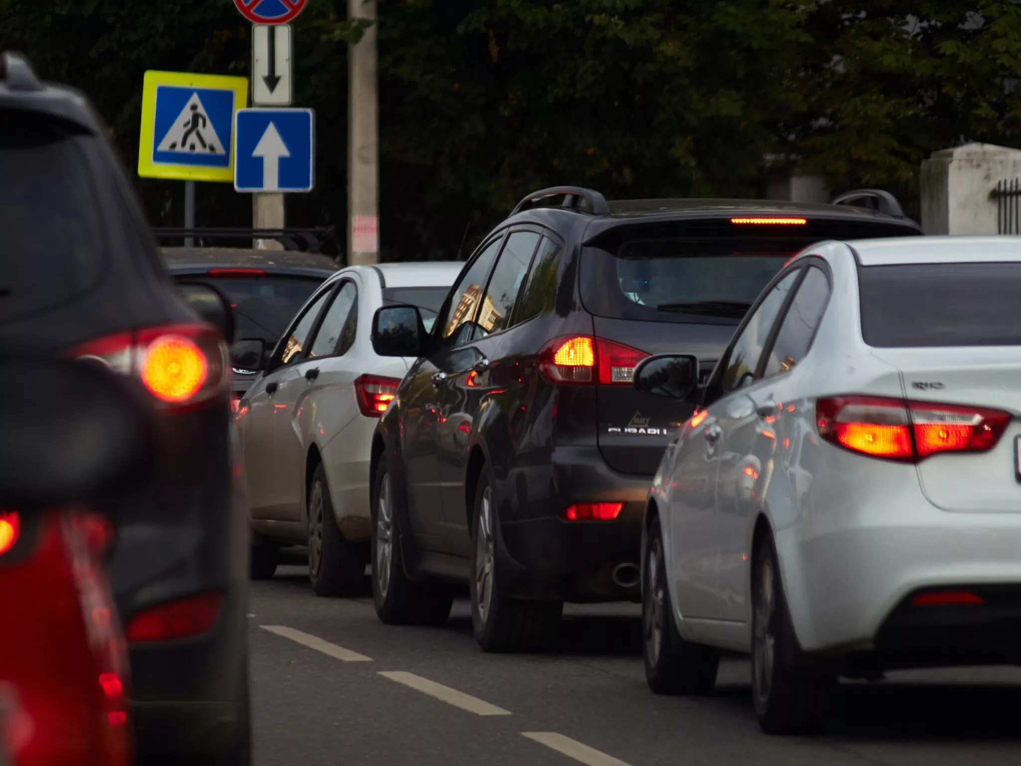 several vehicles lined up at a traffic light