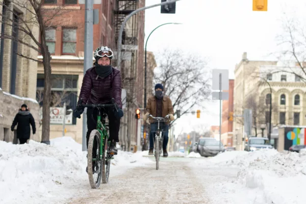 cyclists bundled warmly and riding bikes through the city during the winter