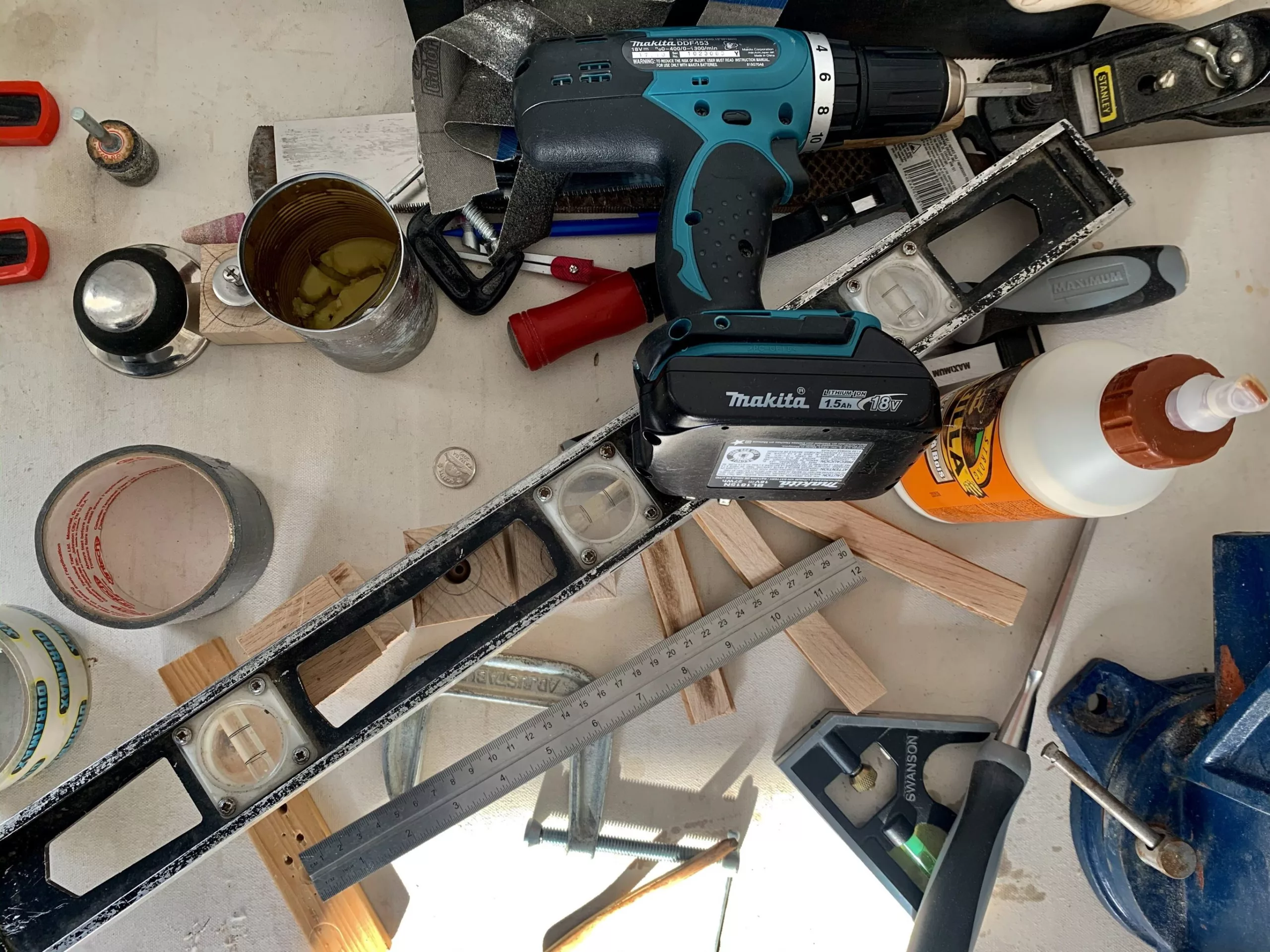 assorted tools spread across a cement floor