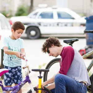 2 boys fixing a bike