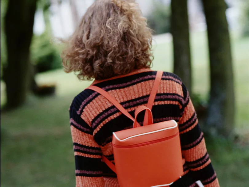 child with backpack walking