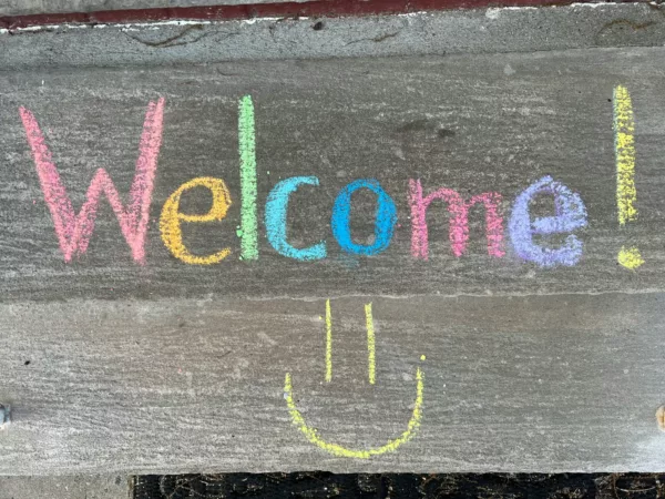 welcome written in colourful chalk