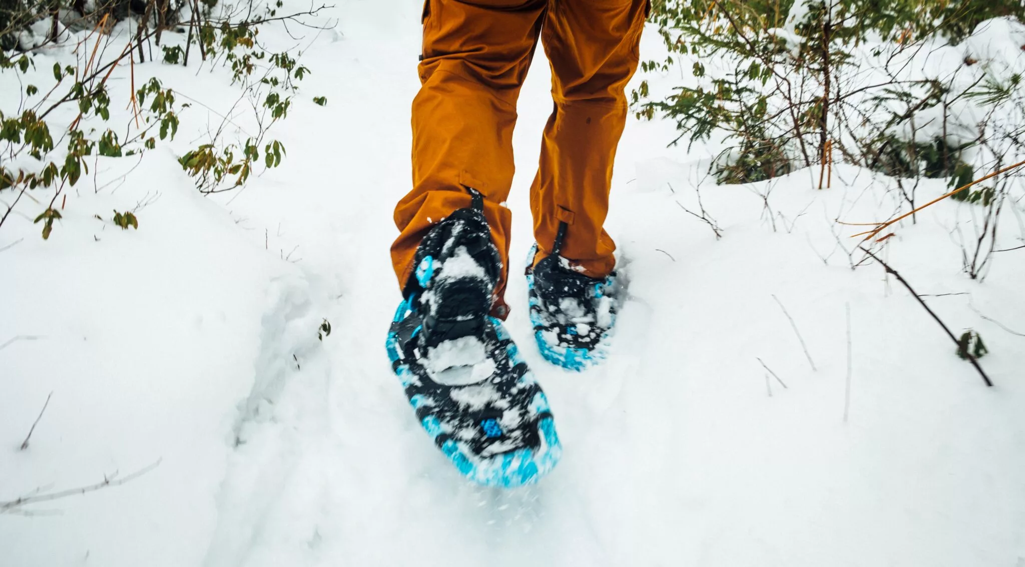 footprints being made as person walks through deep snow