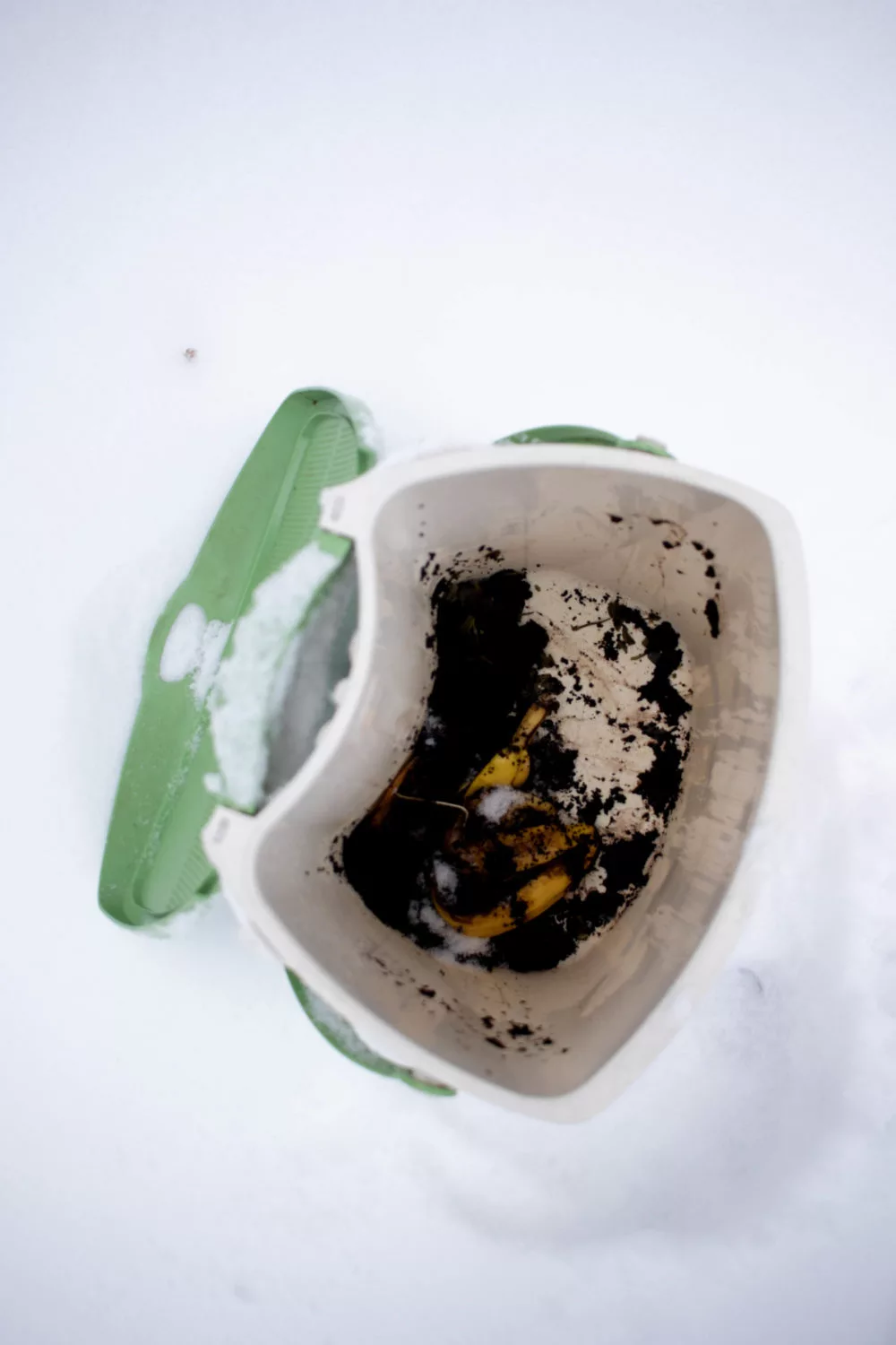 open compost bin outside surrounded by snow